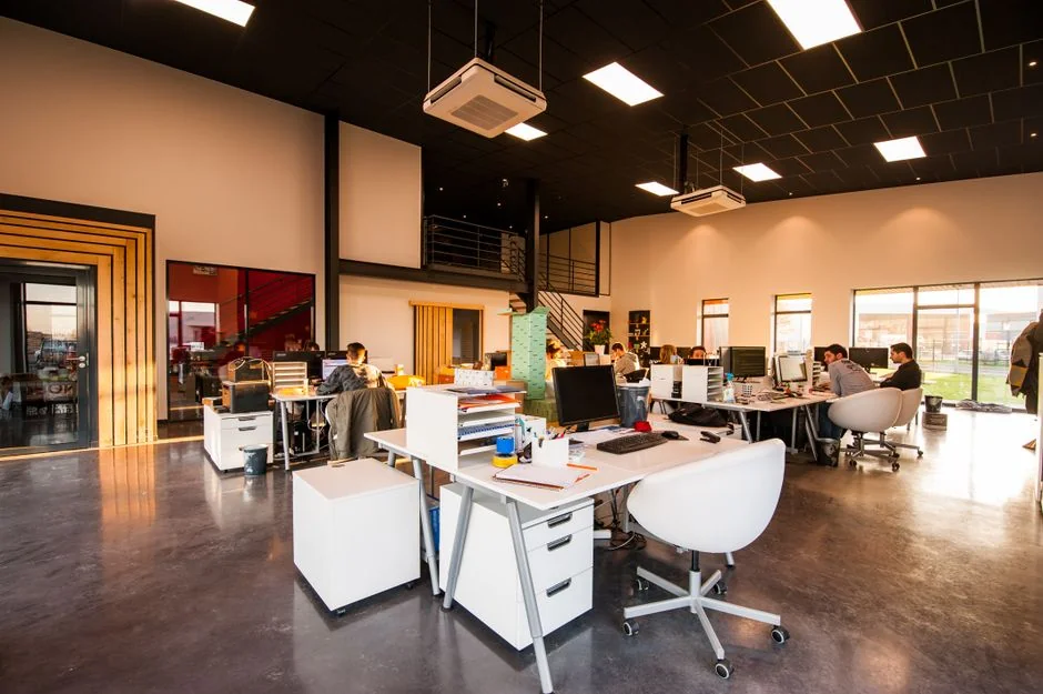 who-we-are A stylish workspace featuring a laptop and monitors displaying design software.